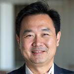 Professional headshot of James Chen, a calm and wise-looking man.